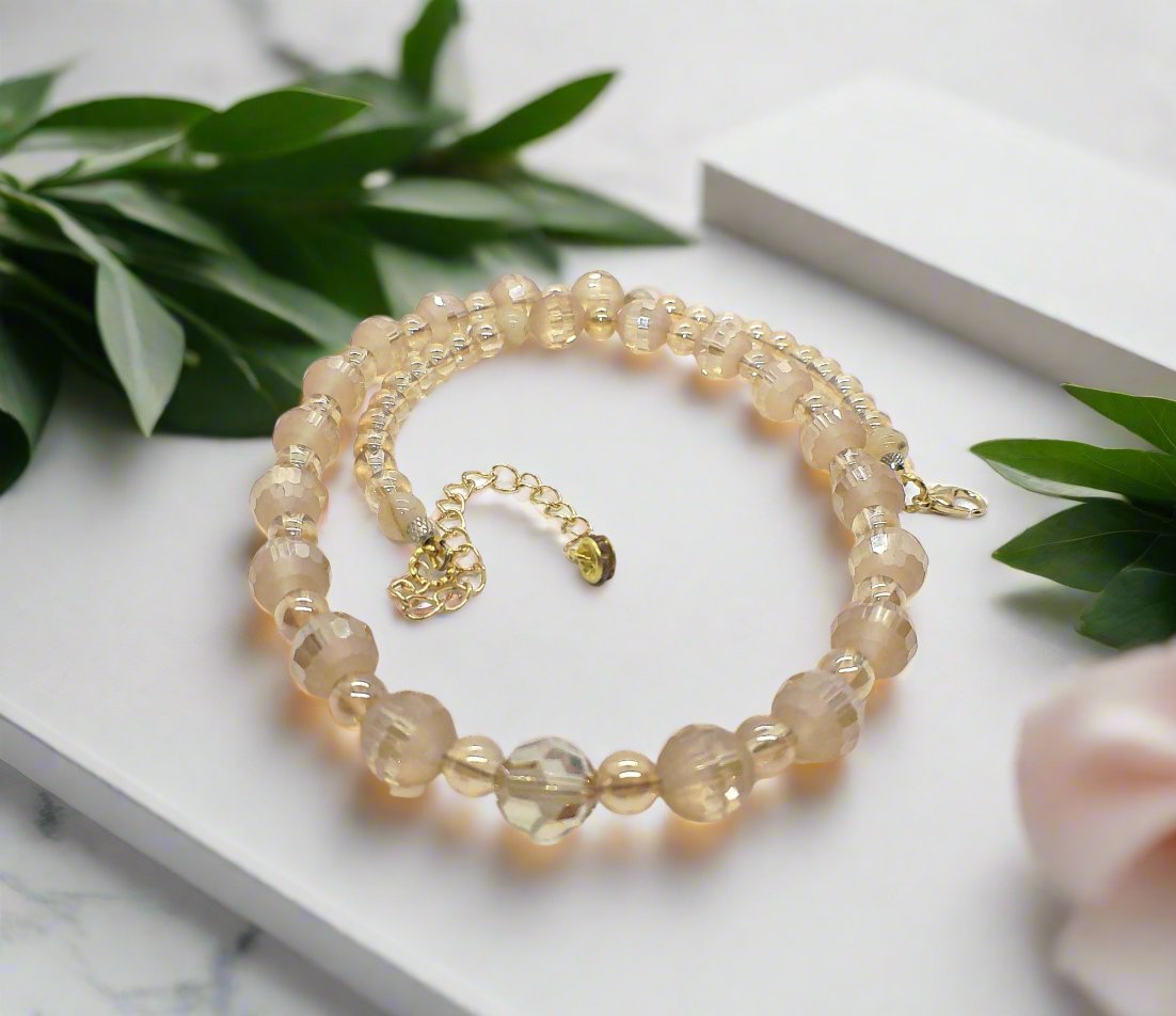 https://www.artistryjewelry.net/products/beautiful-peach-amber-crystal-and-cream-golden-shadow-beaded-necklace-set-handcrafted-by-artistry-jewelry