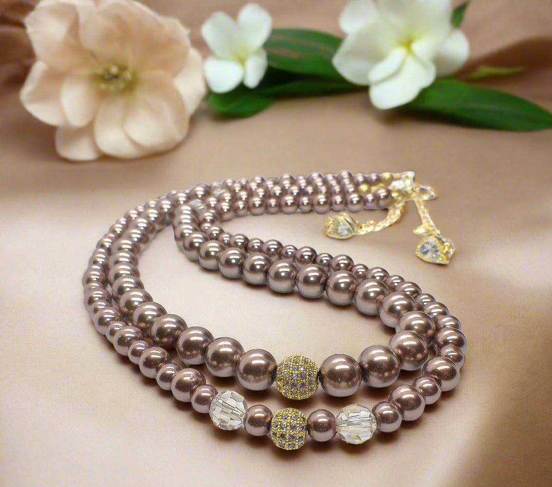 https://www.artistryjewelry.net/products/stunning-crystal-pearl-and-druk-two-strand-beaded-necklace