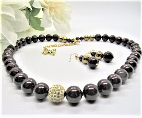 This is an exquisite brown necklace set.  Perfect for any occasion or for a special gift.  Made with Swarvoski Mocca crystals, Swarvoski Pearl Beads, Micro Pave CZ ball.  The earrings have Gold Filled ear hooks.  This set is simply stunning for anyone.